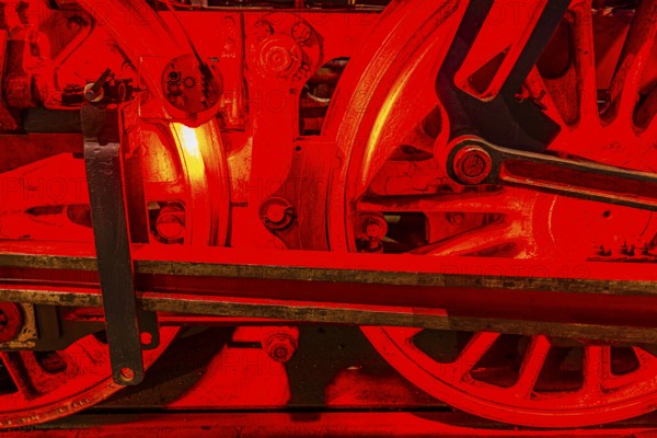 Illuminated wheelwork of a historic locomotive, railway museum, Augsburg railway park,