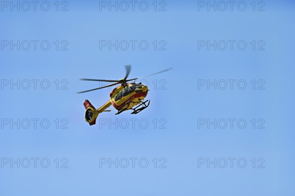 Helicopter flying against a blue sky, alpine rescue, mountain rescue, Chamonix, Haute-Savoie,