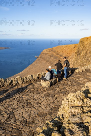 Tourists sitting on a bench on the observation deck at the Mirador del RÃ­o viewpoint, in the