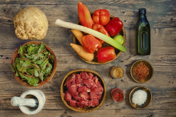 A vibrant assortment of fresh ingredients arranged on a wooden tabletop, illustrating healthy
