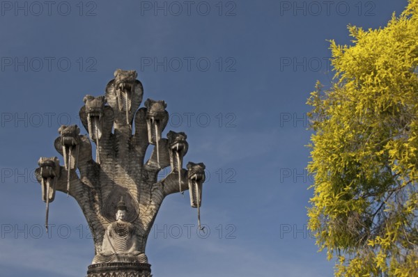 Monumental depiction of Buddha meditating under the protection of a seven-headed naga snake, Wat