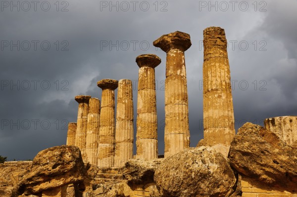 Temple of Heracles, ancient columns under dramatic stormy sky, Valley of the Temples, Valle dei