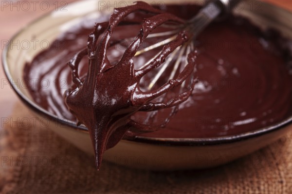 A bowl of chocolate dough, a whisk for whipping, baking, structure and consistency, homemade, top