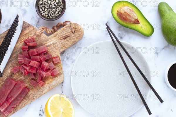 Cooking fresh tuna with ingredients on a marble countertop, ingredients for making sushi and tuna