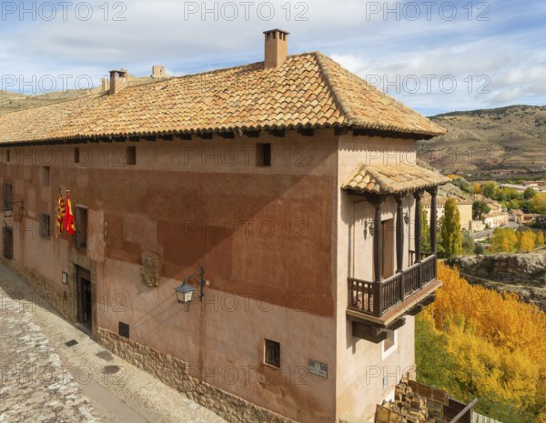 Alberque hostel building with flags flying, historic buildings in medieval village of AlbarracÃ­n,
