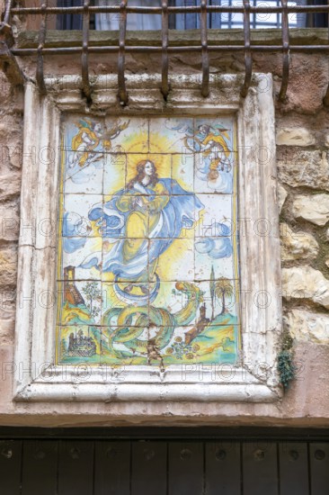 Historic ceramic tiles religious image above doorway, medieval village of AlbarracÃ­n, Teruel