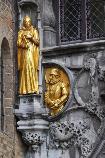 Golden figures on the faÃ§ade of the St. Ivo Chapel at the Basilica of the Holy Blood, Castle