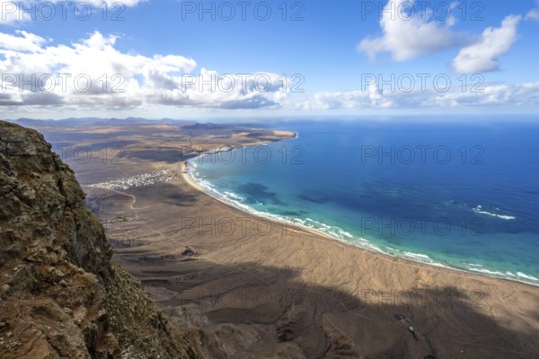 View from the Risco de Famara cliffs to the coast and the sea with the Famara beach, Playa de