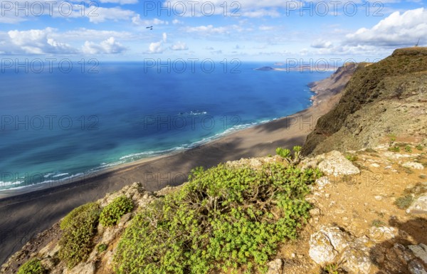 View from the Risco de Famara cliffs to the coast and the sea with the Famara beach, Playa de