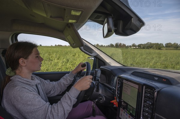 Young girl learns to drive a pickup truck on private property, Mecklenburg-Western Pomerania,