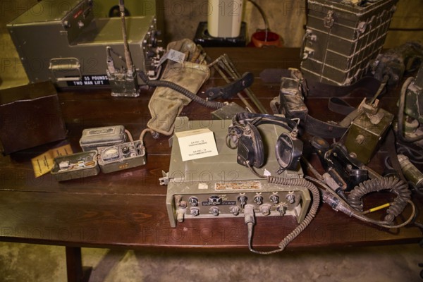 Antique military radio equipment and accessories displayed on a wooden table, War Museum, Military