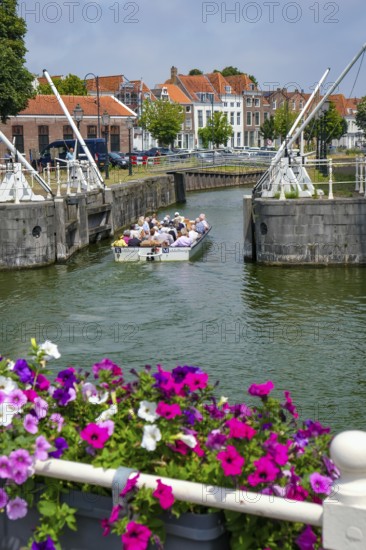 Middelburg, Zeeland, Netherlands - Town houses on the inner harbour in the old town. Tourists take