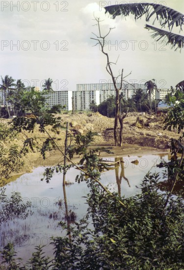 Destruction of farmland for construction site with modern blocks of flats residential housing,