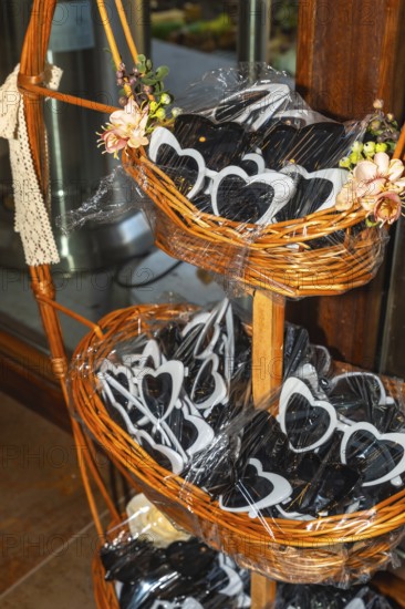 Heart shaped sunglasses are displayed in wicker baskets, adding a playful touch to wedding