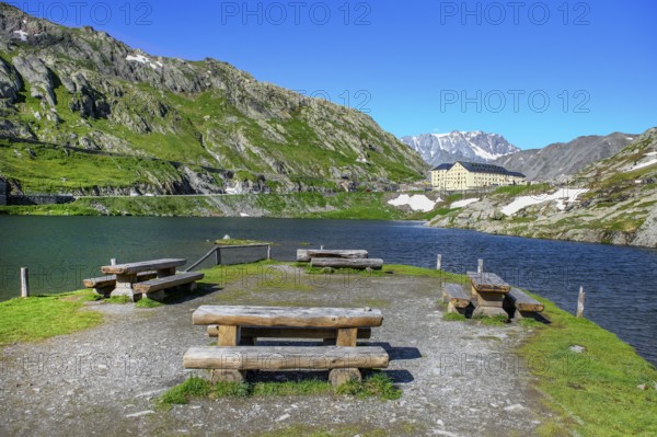 View of small island with wooden benches in mountain lake Alpine lake Lac du Grand Gd Saint St