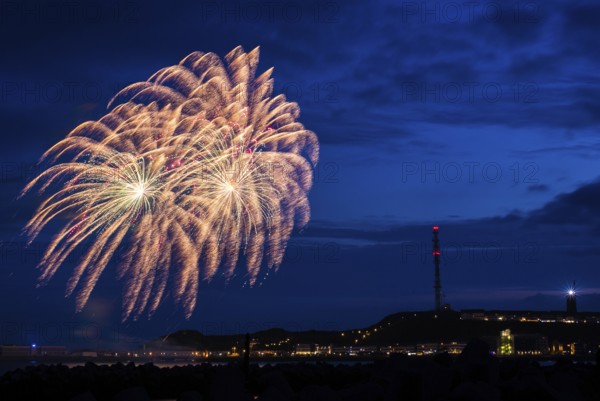 A brilliantly shining, atmospheric firework display for the Heligoland island festival in red and