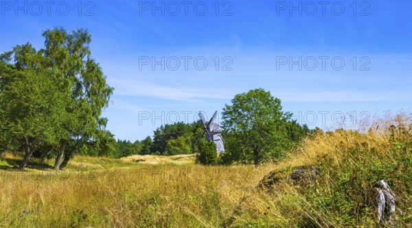 Epic summer landscape with historic windmill near the burial ground of Stenhusbacken and the