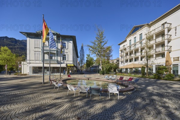 Wisbacherbrunnen, fountain, public chairs, flagpoles, flags, German flag, Bavarian flag, building,