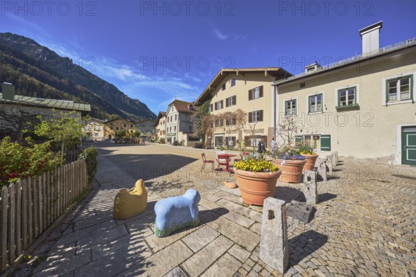Old town, historic houses, square, cobblestones, bollards, wooden fence, facade, windows, bushes,