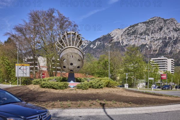 Saltworks roundabout, stainless steel sculpture, salt shaker, trees, lantern, car, mountains,
