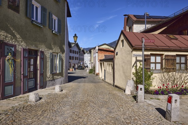 Historic houses, lantern, facade, windows, doors, alleyway, cobblestones, bollards, blue sky,