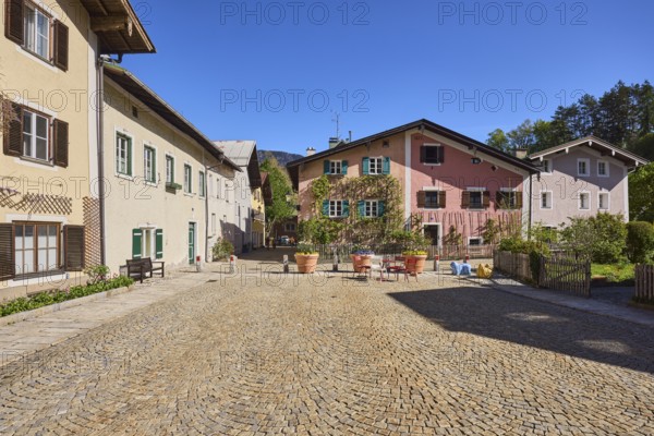 Sichlerhaus, historic building, facade, windows, shutters, square, cobblestones, trees, blue sky,