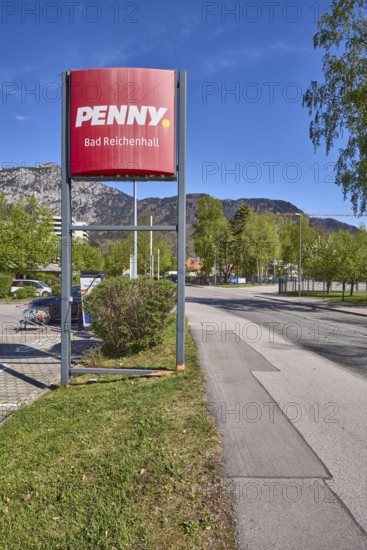 PENNY Markt GmbH, discounter, advertising sign, mountain landscape, mountains, trees, lawn, road,