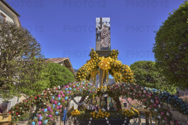 Easter fountain, Easter decoration, blown out coloured Easter eggs, trees, historical buildings,