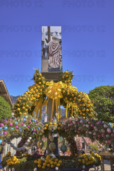 Easter fountain, Easter decoration, blown out coloured Easter eggs, trees, historical buildings,