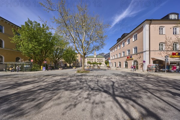 Square, historic town hall, trees, general buildings, pedestrians as secondary motif, shadow, blue
