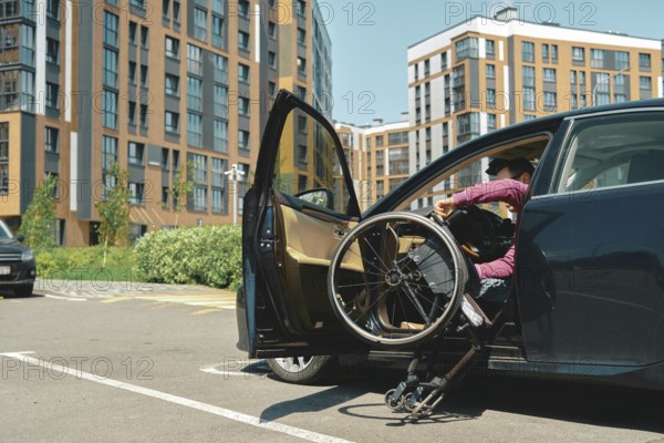 A person is carefully getting out a vehicle using a wheelchair in a bustling parking lot. The
