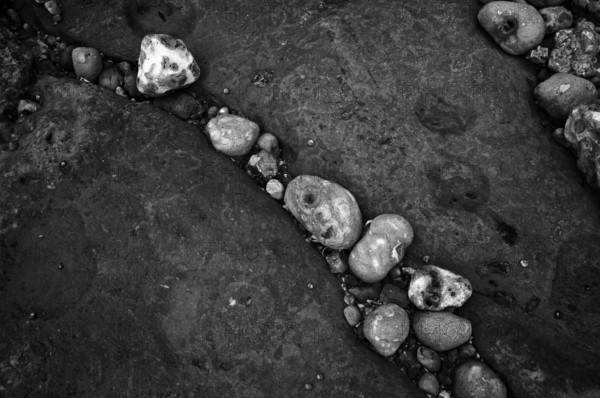 Pebbles, stones, pebbles on the beach, black and white, Yport, chalk cliffs, alabaster coast, La