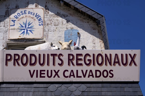 Advertising sign La Rose des Vents. Retail trade, supplier of regional products such as Calvados,