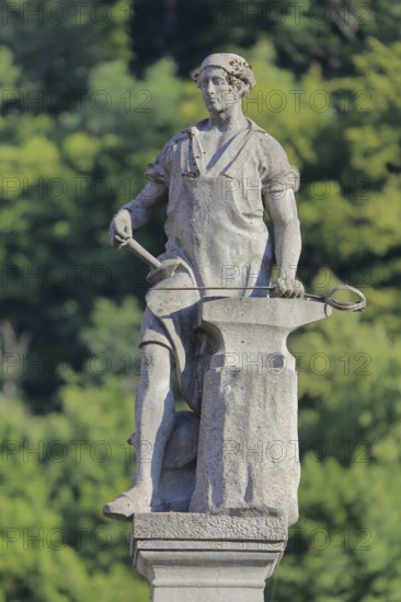 Gunsmith by Georg Ringel as a symbol of the arms industry, anvil, manufacture, production, city