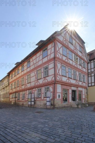 Red half-timbered house against the light, Lutherhaus, Lutherplatz, Schmalkalden, Franconia,