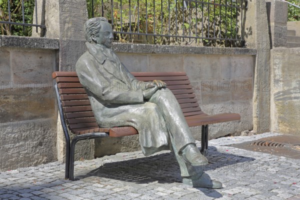 Johann Wolfgang von Goethe by Klaus Gutting sitting on the bench, bronze sculpture, looking, arms,