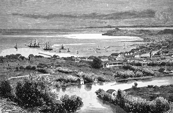 Trondheim on the fjord and river Nidelva, tall ship in roadstead, street with houses by the sea,