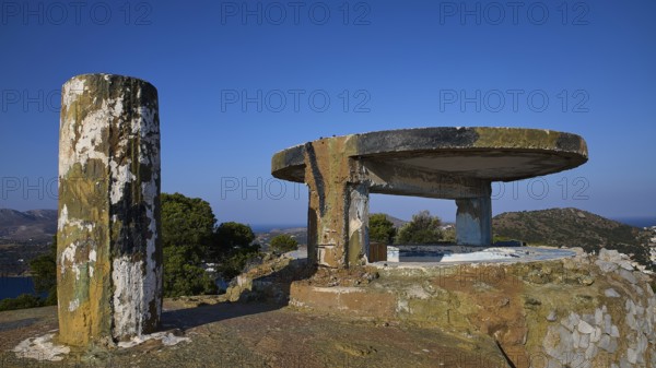 Concrete bunker with round platform high on a hill under a clear sky, Lost Place, Lago