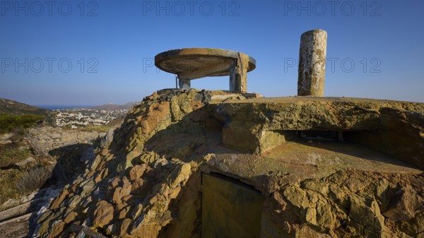 An old, dilapidated concrete building on a hill with a sea backdrop, Lost Place, Lago anti-aircraft