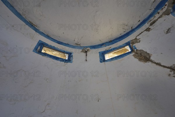 Interior of an abandoned dome with blue window frames and peeling plaster, Lost Place, Lago