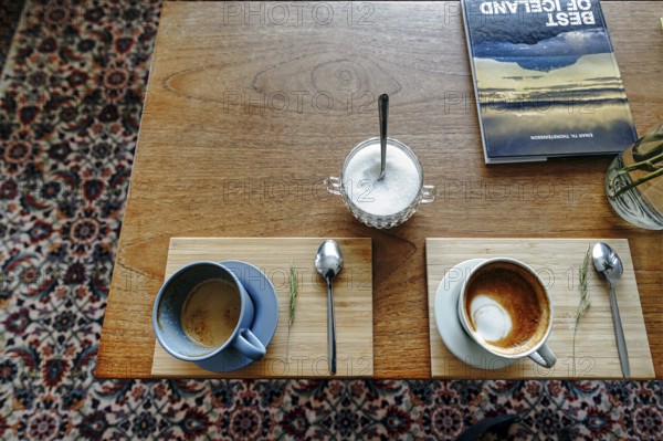 Two cups of coffee, cappuccino, coffee speciality, table decoration in a café, view from above,
