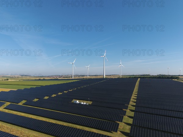Extensive solar panels with wind turbines in sunny surroundings, near Kitzingen, Lower Franconia,