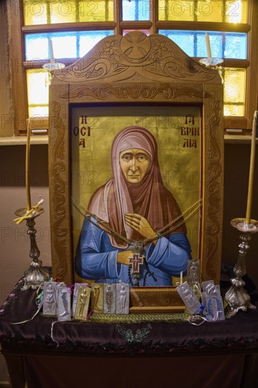 Icon of Panagia Kyra, Religious icon on an altar with candles and decorative details in an
