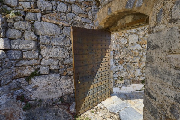Rustic wooden gate in a stone-lined ruin, historical atmosphere, Pandeli Castle, castle, Leros