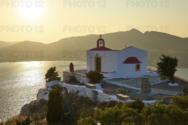 Chapel on a hill overlooking the sea and the mountains at sunset, Profitis Ilias Church, Prophet