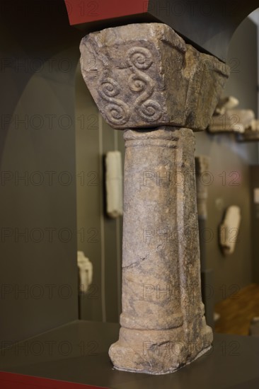 Decorated stone column with relief details, exhibited in a museum, Archaeological Museum, Agia