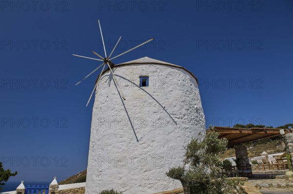 Single white windmill with large propeller under clear blue sky, Pandeli Castle, Castle, Leros