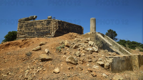 Old, crumbling structure on a desert-like terrain with rubble, Lost Place, Air Defence Position,