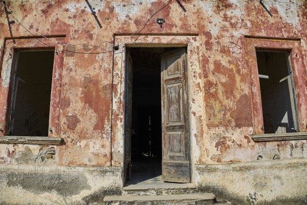 Lost Place, Old façade with open door and peeling plaster, a picture of decay, Radio Station, WW2,