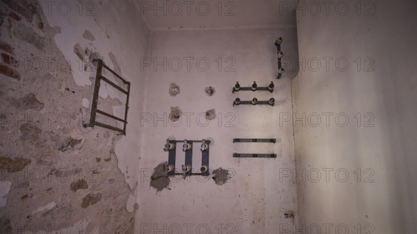 Lost Place, An empty white room with remains of pipes on the walls, electrical installations, Radio